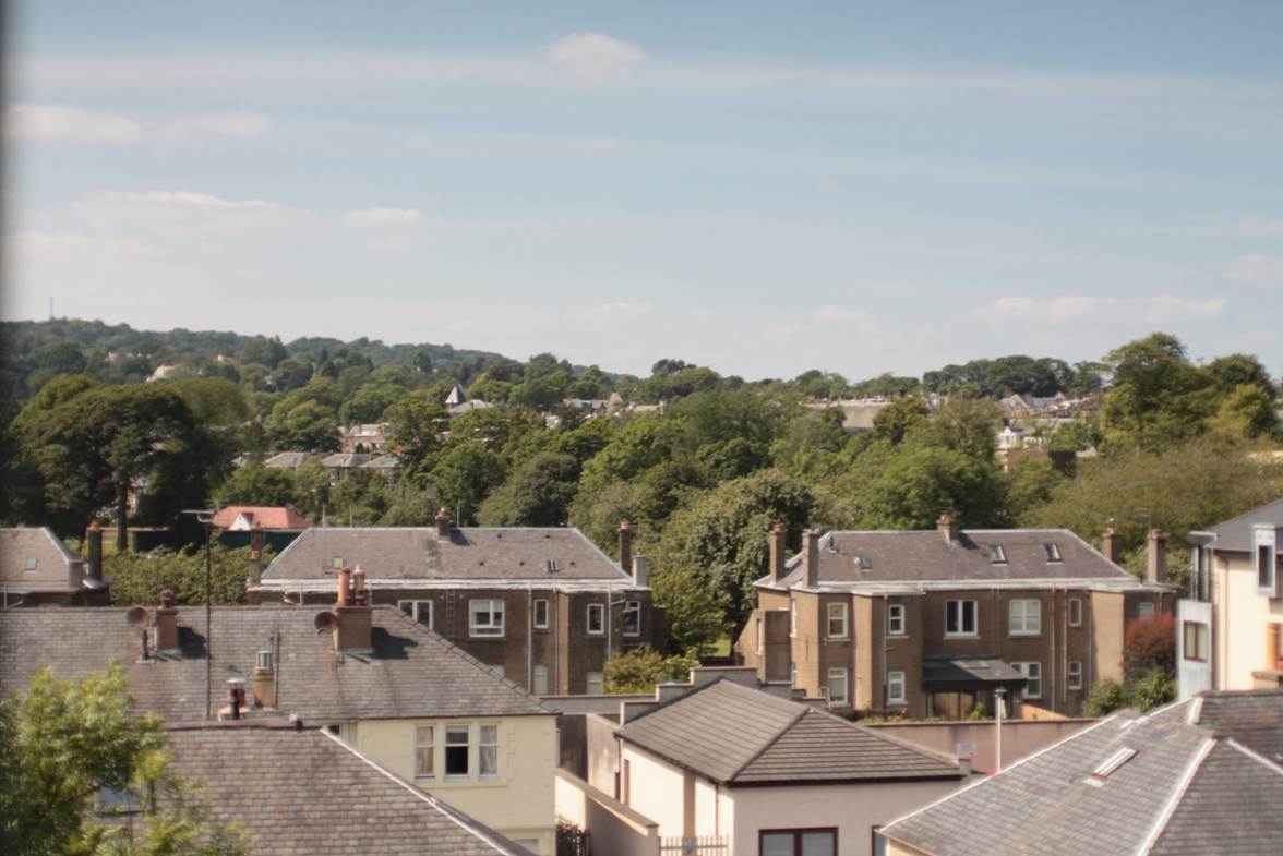 A group of houses with trees in the background