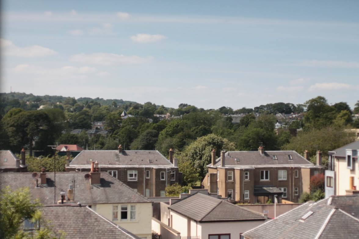 A group of houses with trees in the background