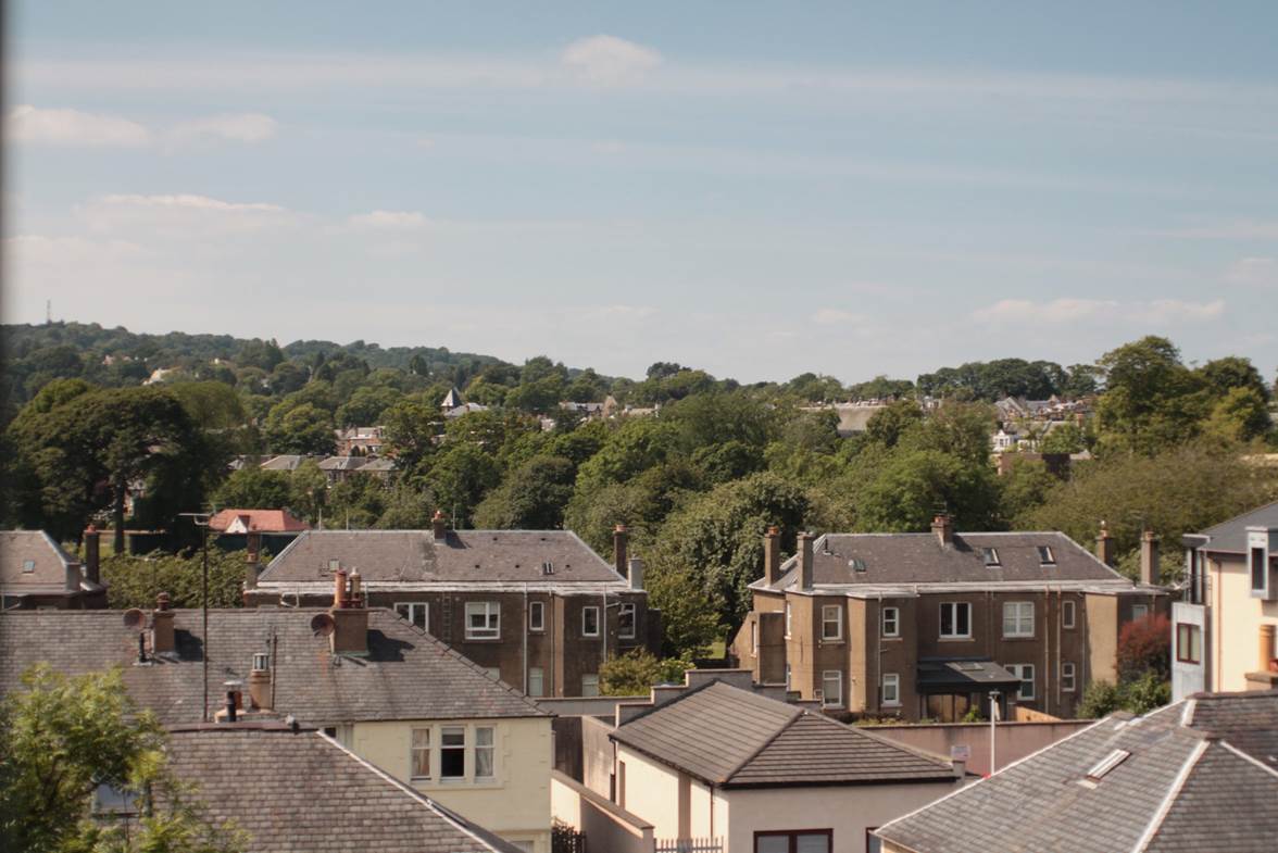 A group of houses with trees in the background