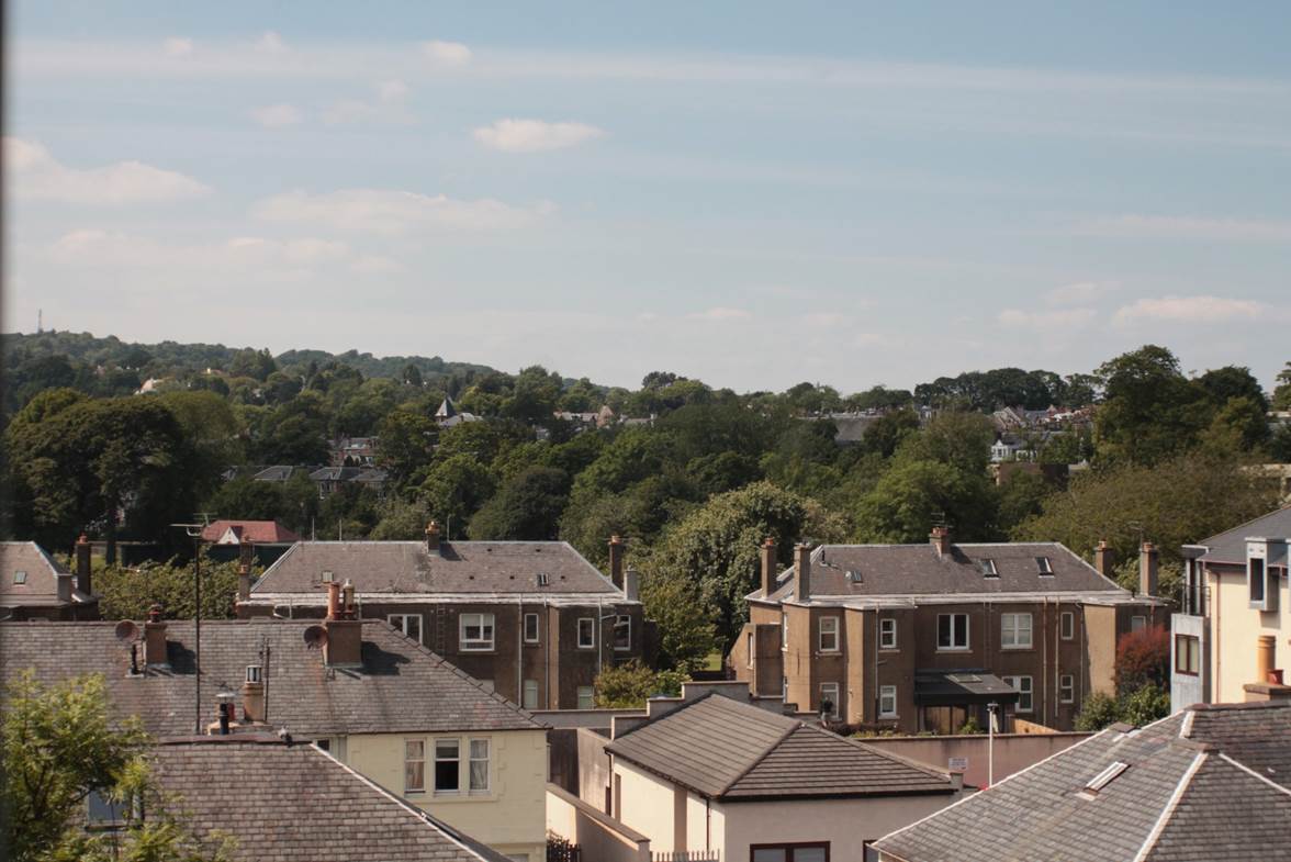 A group of houses with trees in the background