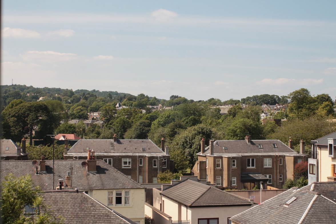 A group of houses with trees in the background