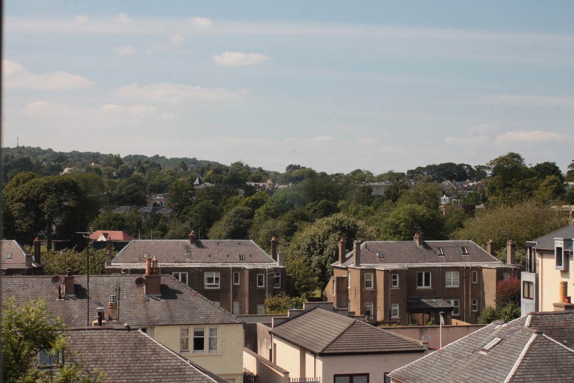 A group of houses with trees in the background