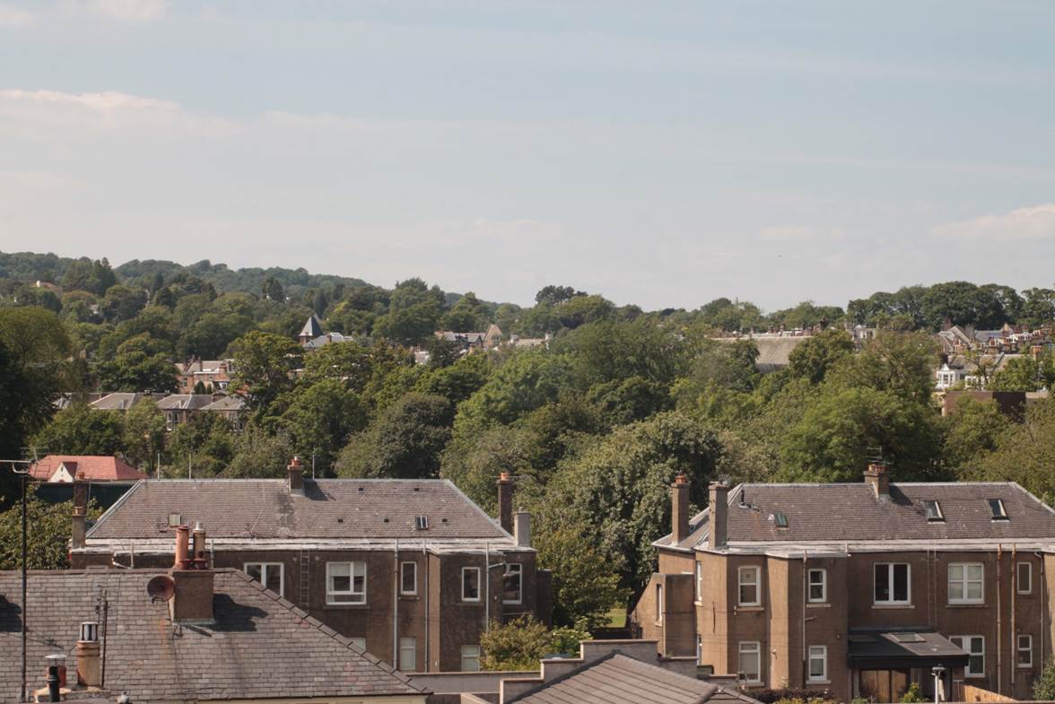 A group of houses with trees in the background