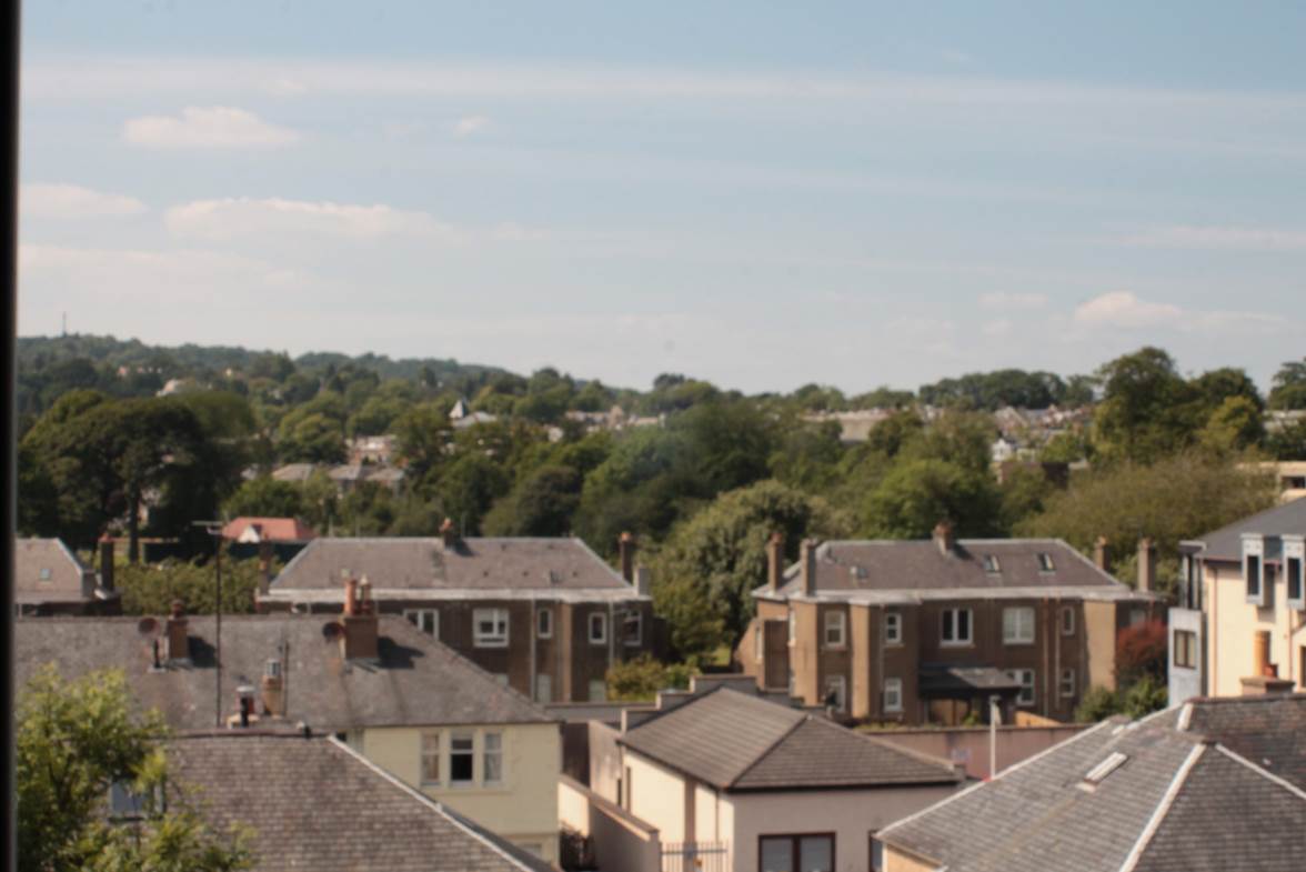 A group of houses with trees in the background